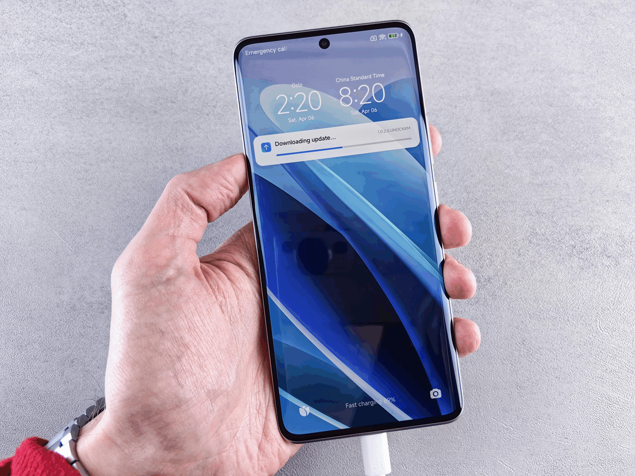 Best Practices for Buying Software Online Safely 2 A person holding a phone with updates being downloaded.