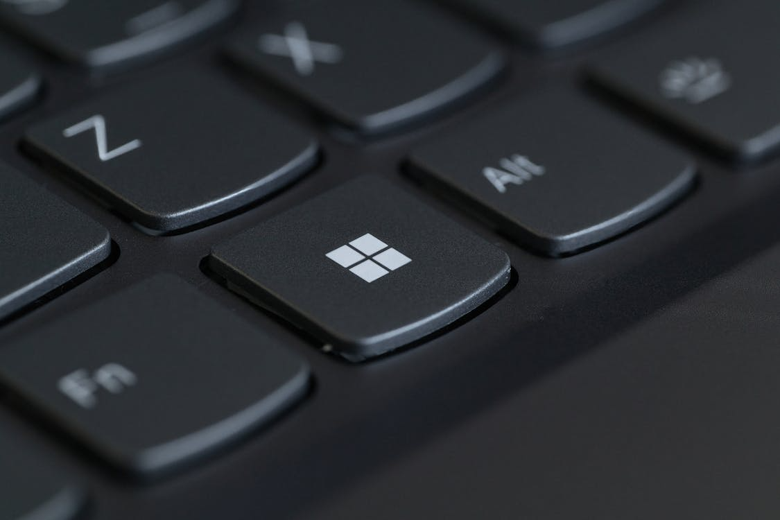 he Ultimate Guide to Buying Microsoft Office Online: Editions, Pricing, and Best Deals for 2024 5 close-up of a black laptop keyboard with the Windows logo on one of the keys